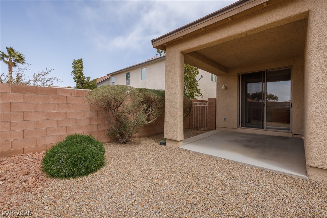 787 Rise Canyon Drive Henderson, NV 89052 - Photo 21 of 22 Relax on the covered patio, extending your living space to the low-maintenance, gravel backyard.