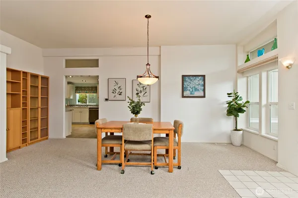 a dining room with furniture and window