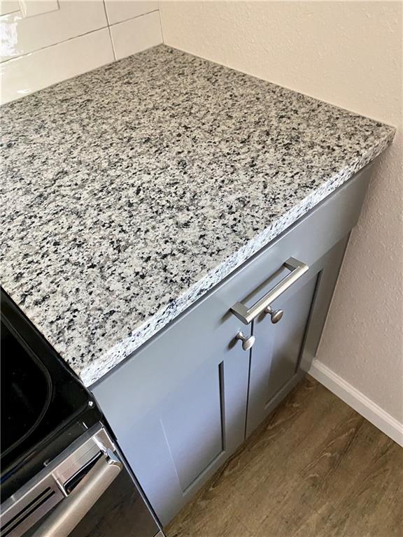 1715 Shadowview Drive, Unit B Austin, TX 78758 - Photo 17 of 28 Refined gray cabinetry pairs seamlessly with granite countertops in this culinary space.