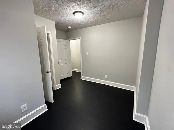 an empty room with wooden floor and closet