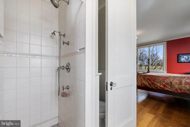 a front view of a house with balcony and garden