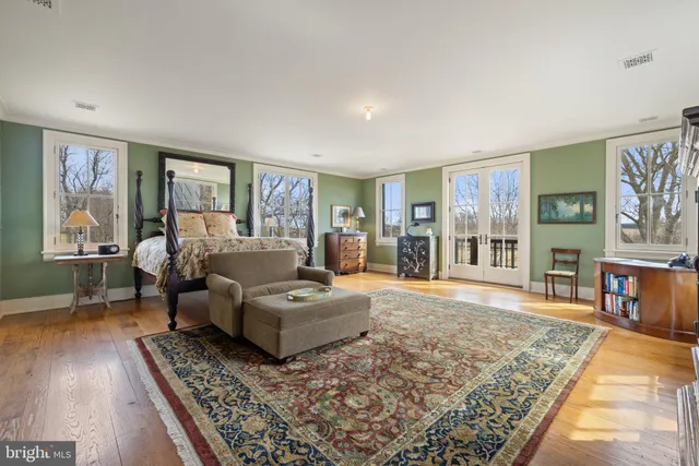 an aerial view of a house with a swimming pool and outdoor seating