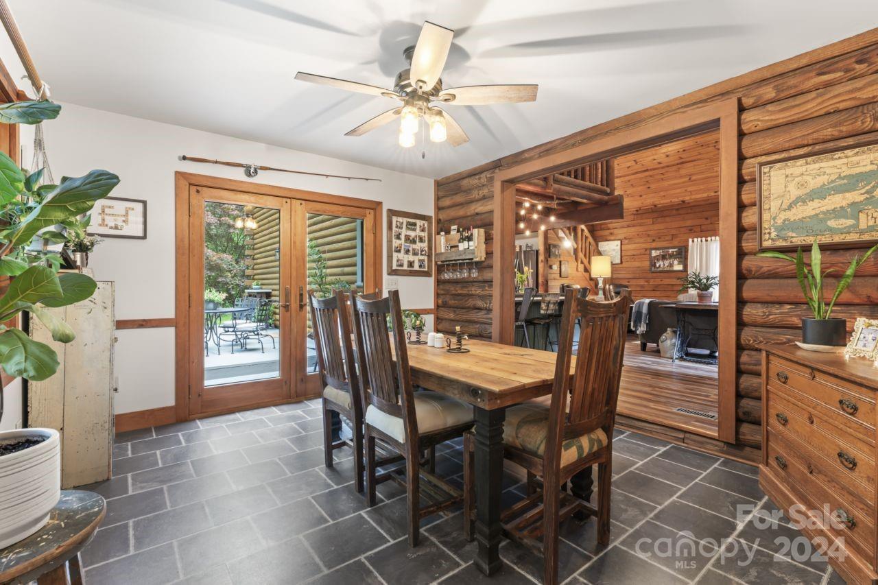 2440 Sloop Road Mount Ulla, NC 28125 - Photo 16 of 48 a dining room with furniture potted plants and wooden floor
