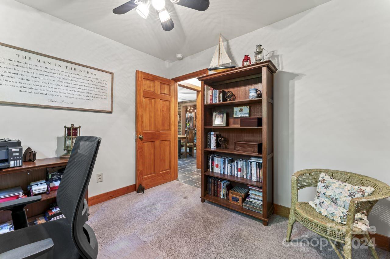 2440 Sloop Road Mount Ulla, NC 28125 - Photo 18 of 48 a view of a workspace with furniture and a bookshelf