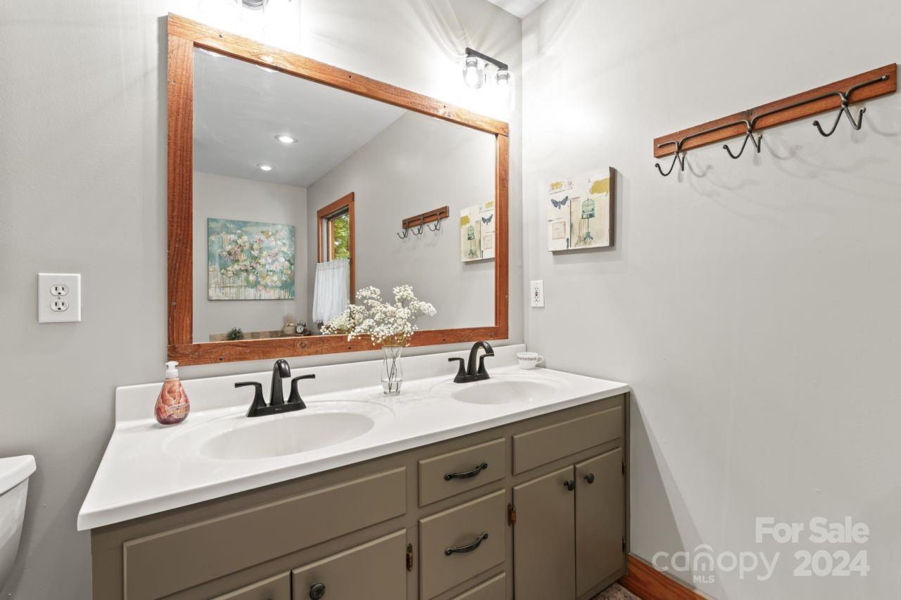 2440 Sloop Road Mount Ulla, NC 28125 - Photo 19 of 48 a bathroom with a sink and a mirror