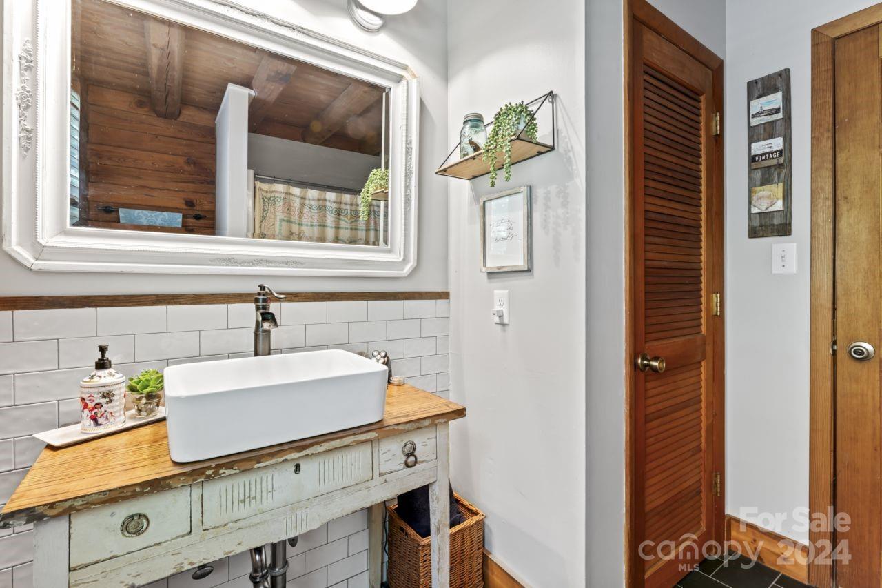 2440 Sloop Road Mount Ulla, NC 28125 - Photo 2 of 48 a bathroom with a sink and a mirror