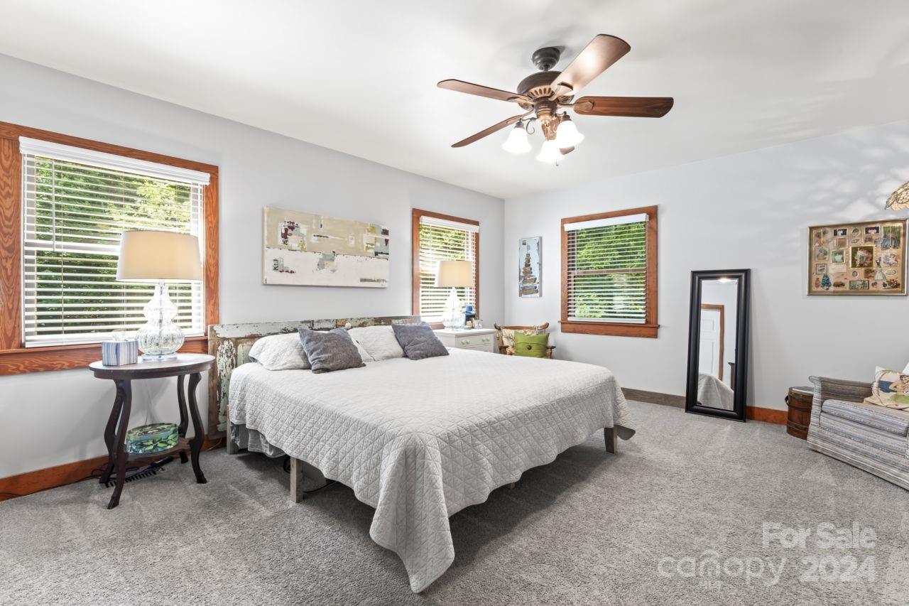 2440 Sloop Road Mount Ulla, NC 28125 - Photo 21 of 48 a bedroom with a bed and a table in it with window