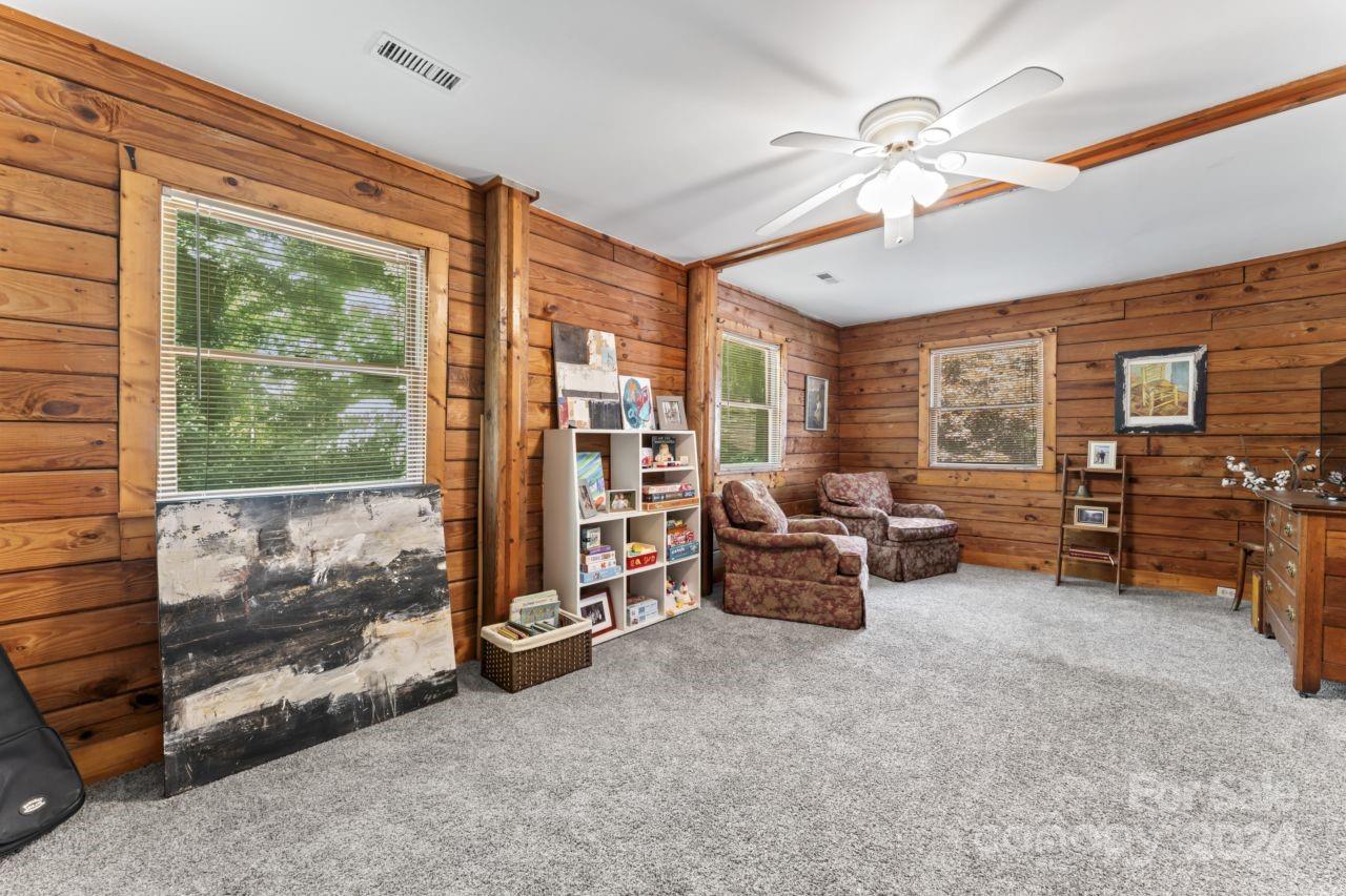 2440 Sloop Road Mount Ulla, NC 28125 - Photo 25 of 48 a living room with furniture and large windows