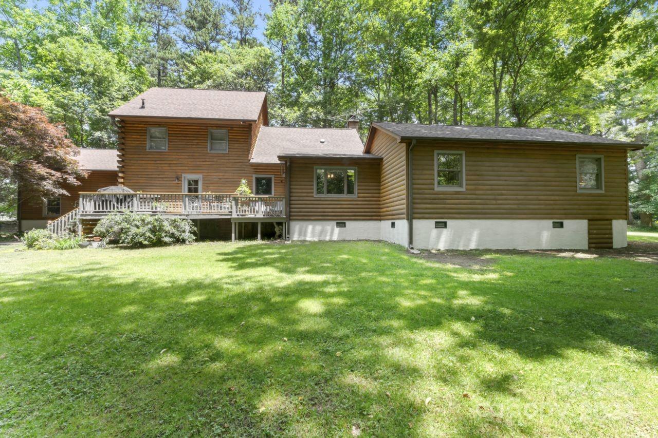 2440 Sloop Road Mount Ulla, NC 28125 - Photo 38 of 48 a front view of a house with a garden