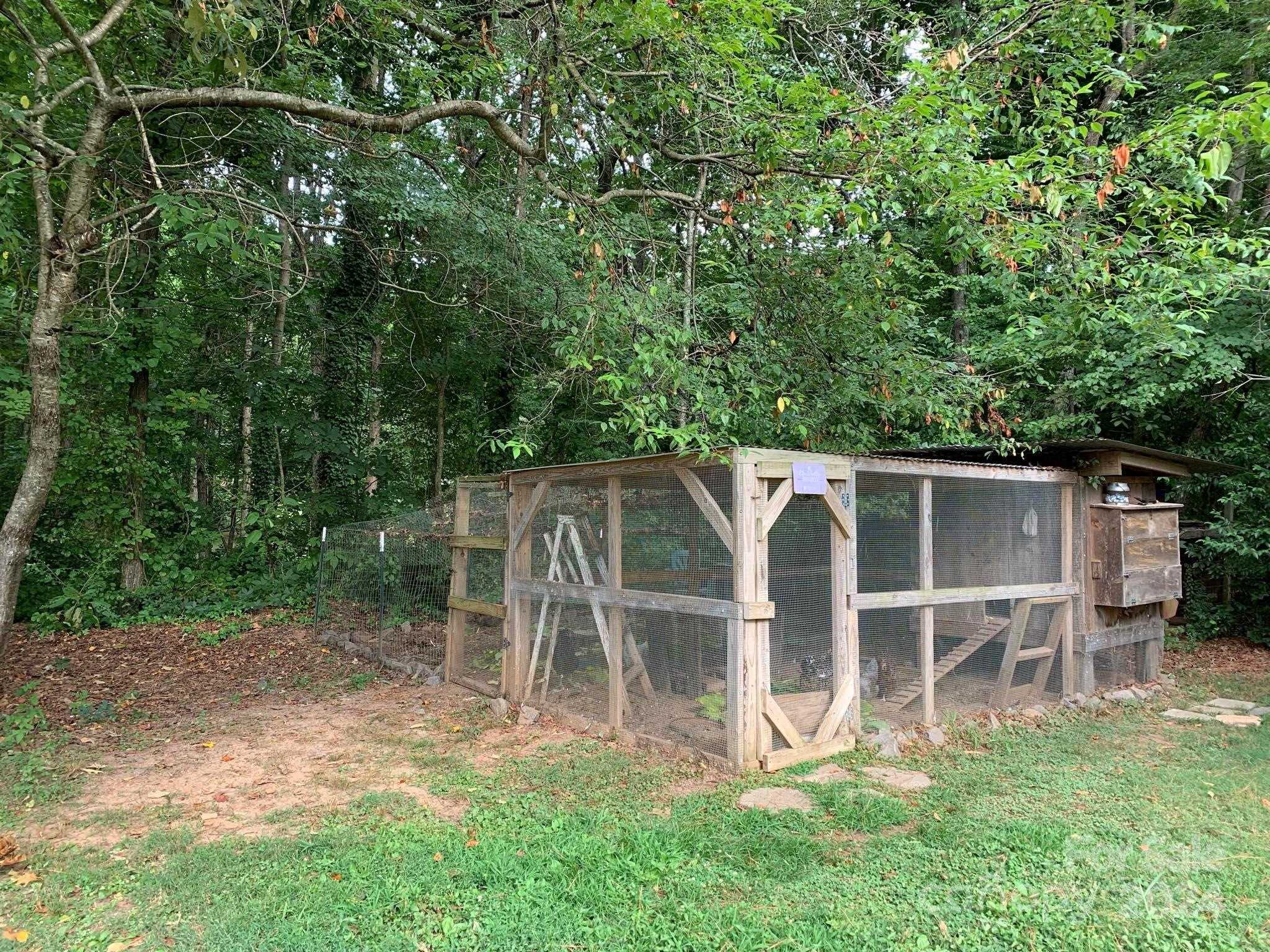 2440 Sloop Road Mount Ulla, NC 28125 - Photo 44 of 48 a view of a backyard with table and chairs with wooden fence and plants