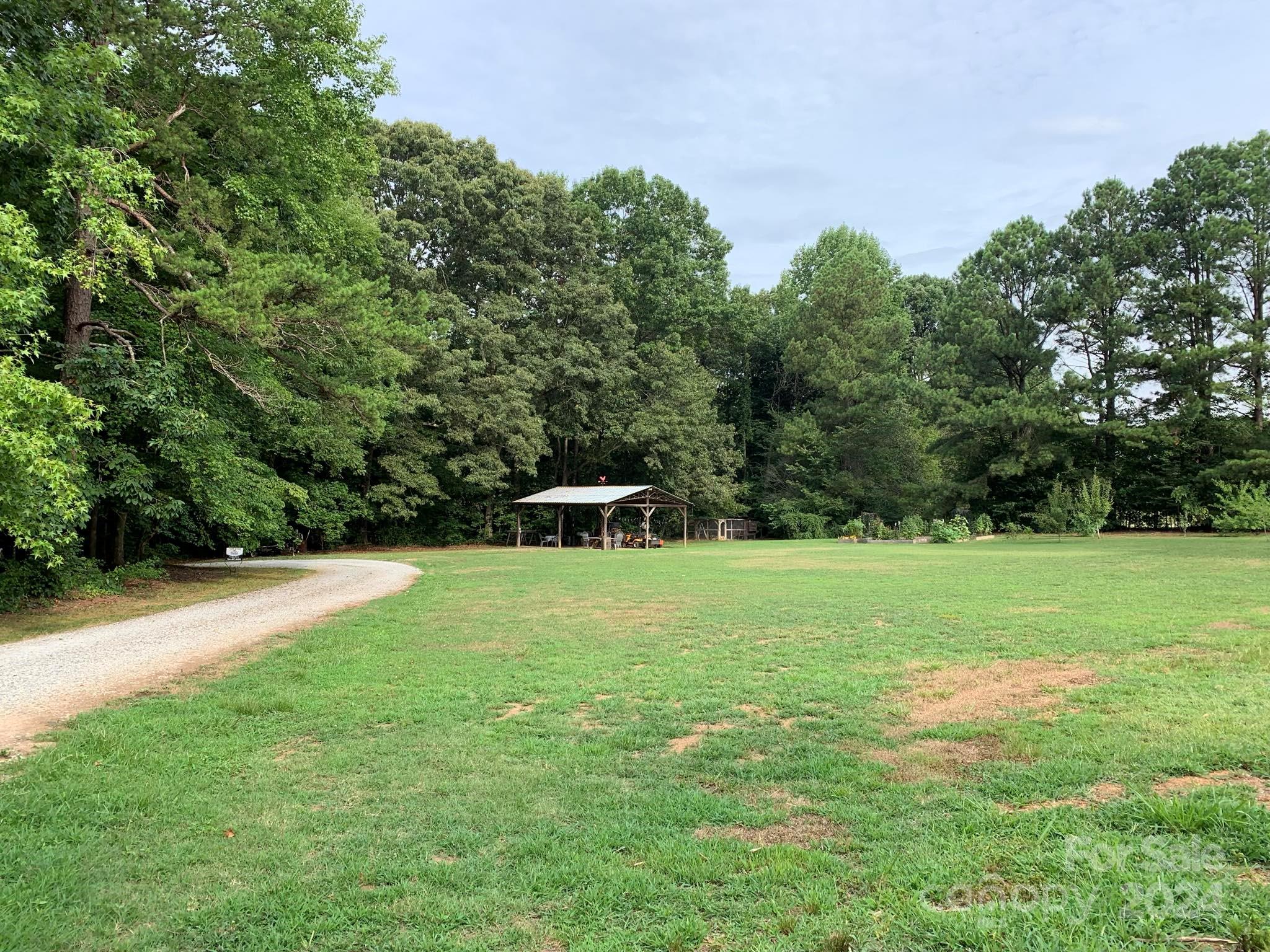 2440 Sloop Road Mount Ulla, NC 28125 - Photo 45 of 48 a backyard of a house with lots of green space