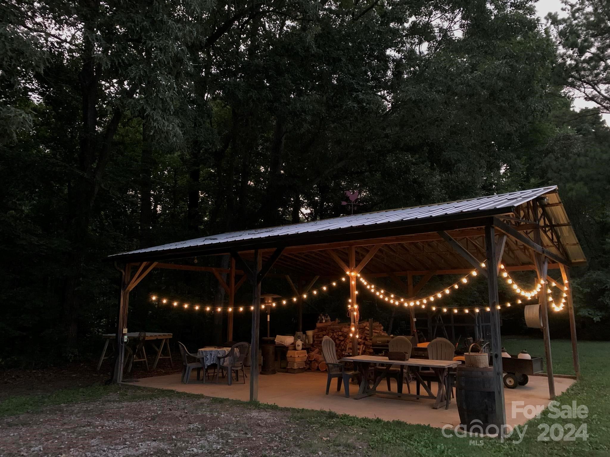2440 Sloop Road Mount Ulla, NC 28125 - Photo 46 of 48 a view of patio with table and chairs a fire pit and a yard