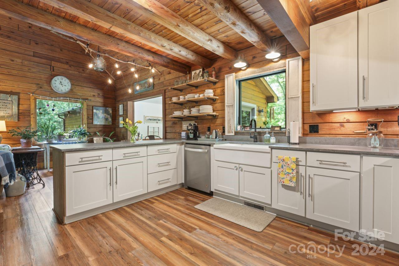2440 Sloop Road Mount Ulla, NC 28125 - Photo 6 of 48 a kitchen with a sink window and cabinets