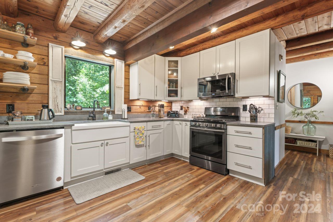 2440 Sloop Road Mount Ulla, NC 28125 - Photo 7 of 48 a kitchen with a stove a sink and a microwave