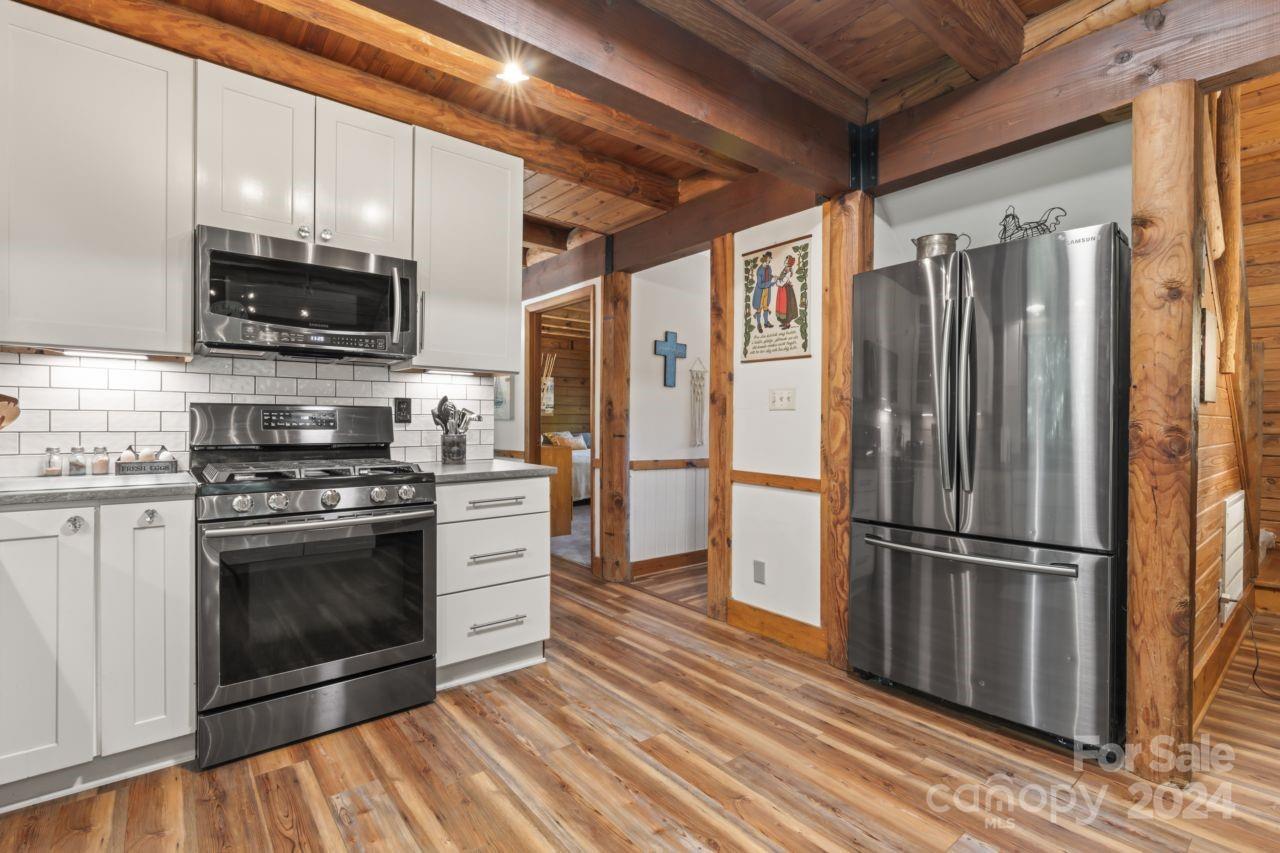 2440 Sloop Road Mount Ulla, NC 28125 - Photo 8 of 48 a kitchen with stainless steel appliances a stove a refrigerator and a microwave