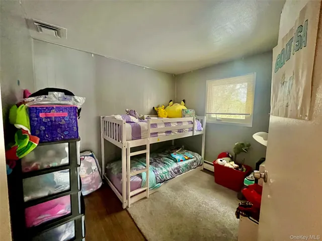a bedroom with furniture and a wooden floor