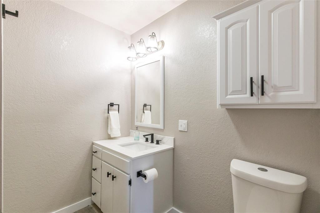 601 North Ave G Haskell, TX 79521 - Photo 12 of 36 a bathroom with a sink a toilet and mirror