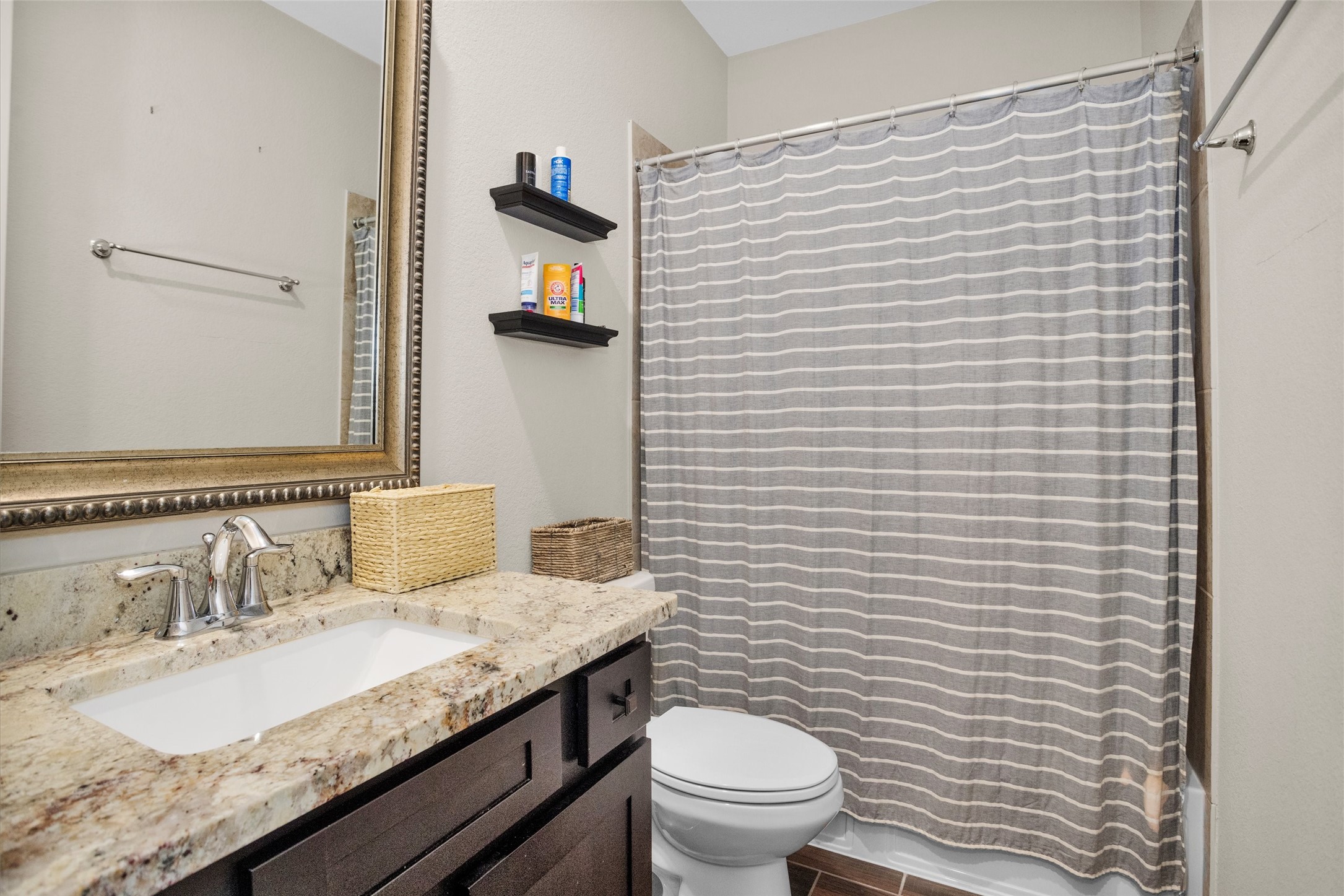 7451 Bethpage Lane Spring, TX 77389 - Photo 20 of 31 a bathroom with a granite countertop sink toilet and mirror