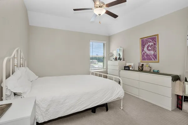 a bedroom with two beds and a chandelier