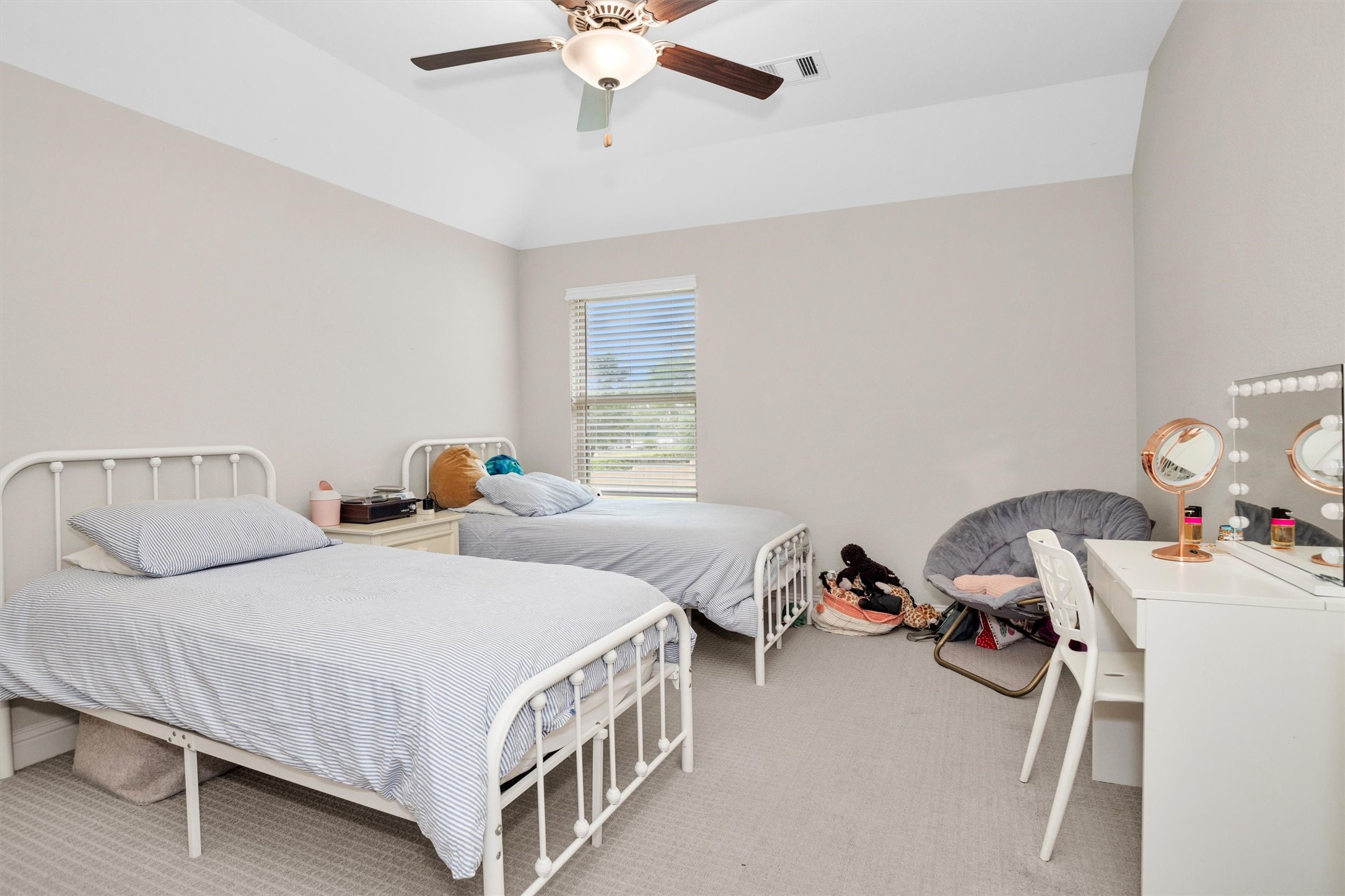 7451 Bethpage Lane Spring, TX 77389 - Photo 25 of 31 a bedroom with two beds and a chandelier