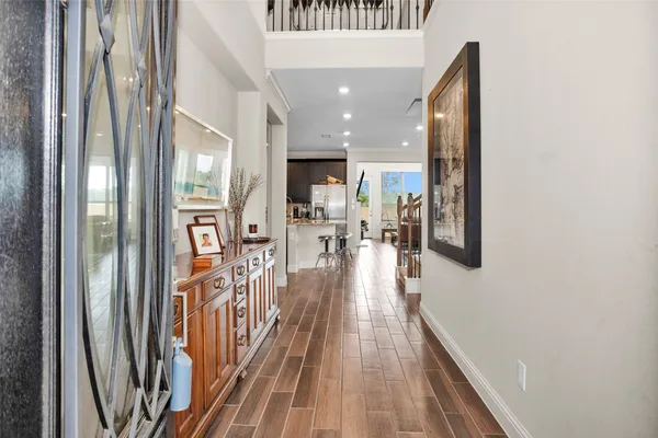a view of a hallway view with wooden floor and staircase
