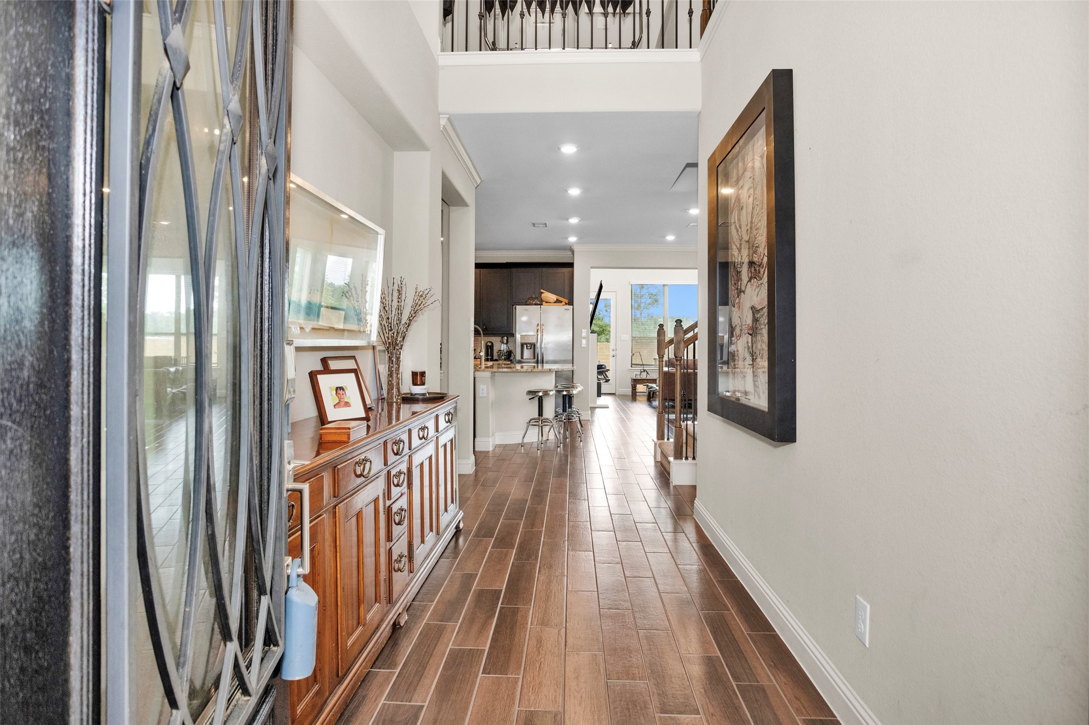 7451 Bethpage Lane Spring, TX 77389 - Photo 4 of 31 a view of a hallway with wooden floor and a living room
