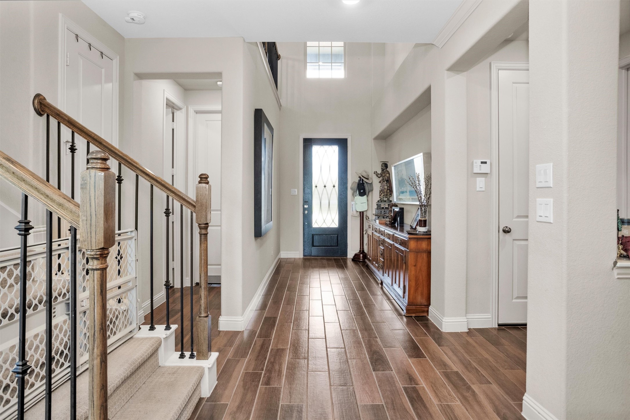 7451 Bethpage Lane Spring, TX 77389 - Photo 5 of 31 a view of a hallway view with wooden floor and staircase