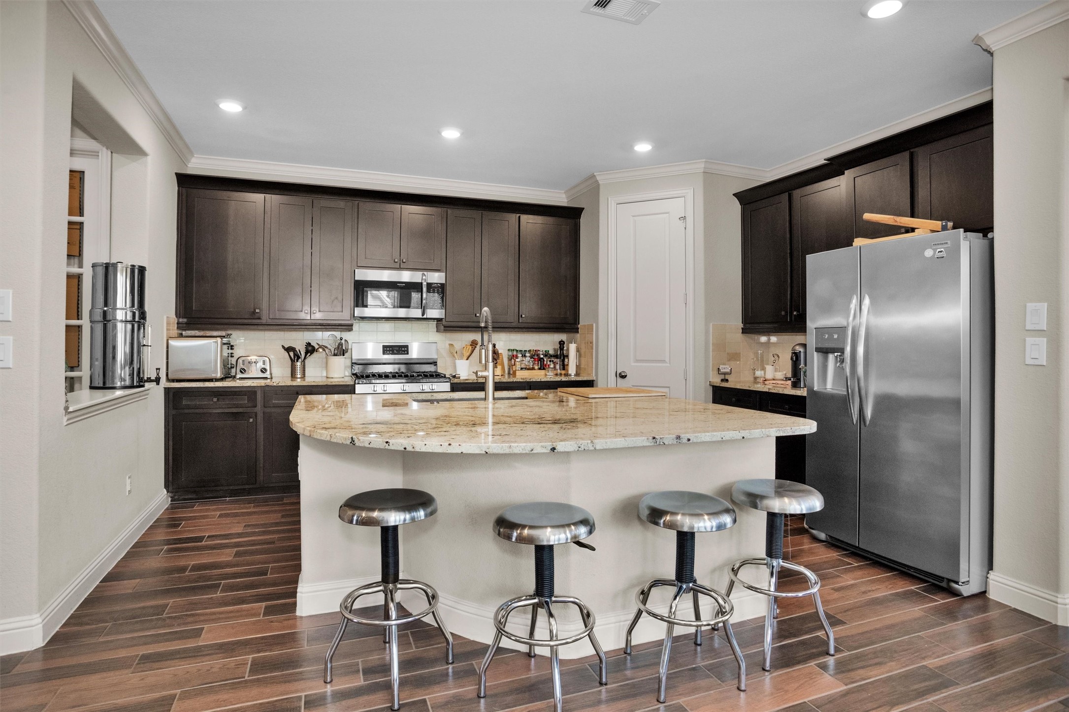 7451 Bethpage Lane Spring, TX 77389 - Photo 6 of 31 a kitchen with stainless steel appliances granite countertop a refrigerator a stove a sink and a microwave