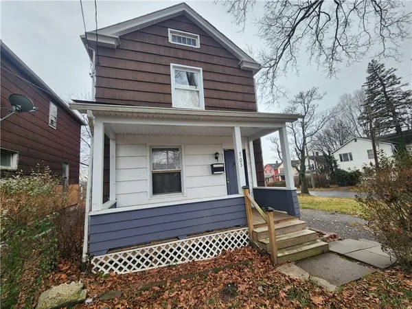 a front view of a house with a garden