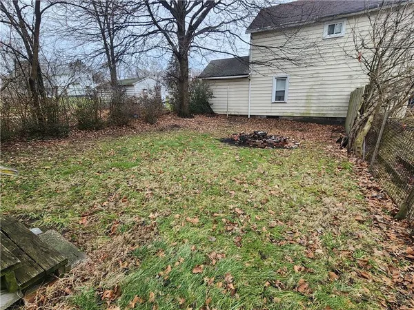 a backyard of a house with large trees