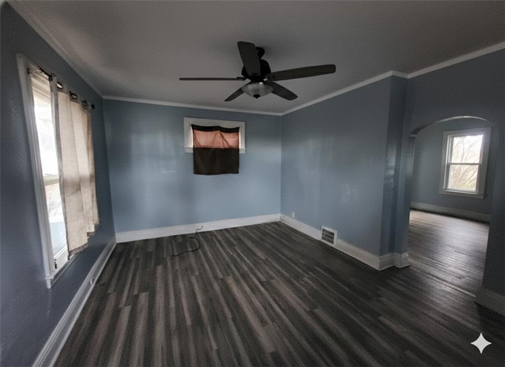 703 French Street Farrell, PA 16121 - Photo 2 of 14 a view of an empty room with wooden floor and a window