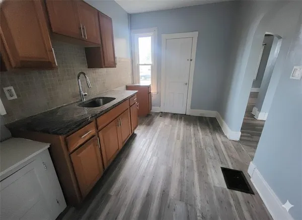 a kitchen with wooden floors and a sink