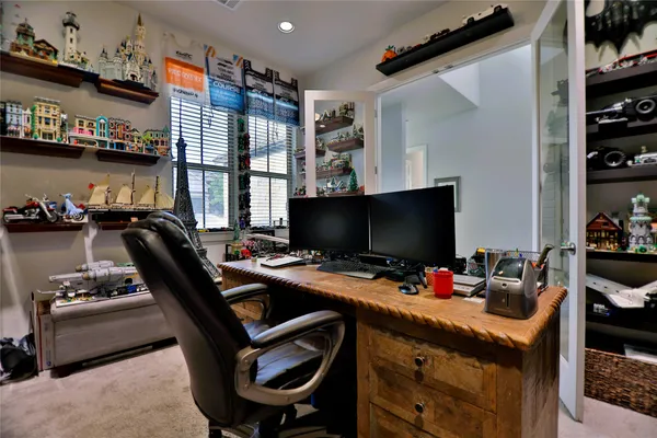 a bedroom with a large bed and ceiling fan