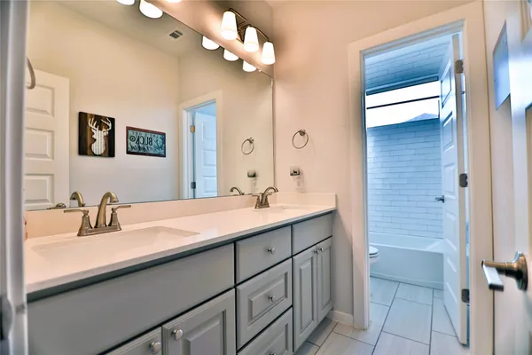 a kitchen with kitchen island a sink table and chairs
