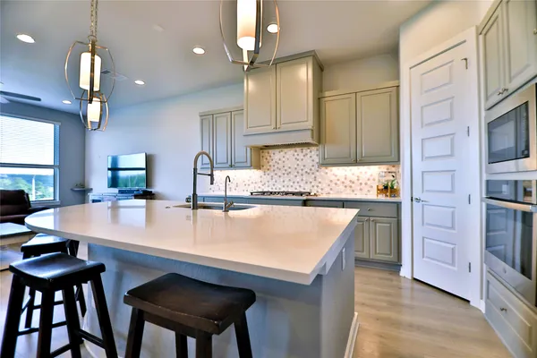 a bedroom with a large bed and a chandelier