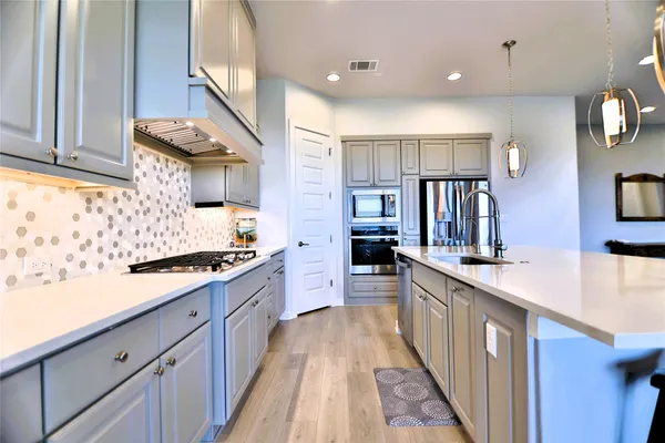 a bedroom with bed and a chandelier