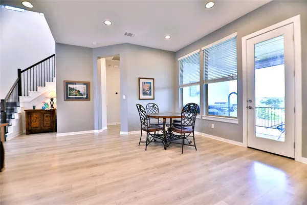 a balcony with furniture and painting on the wall
