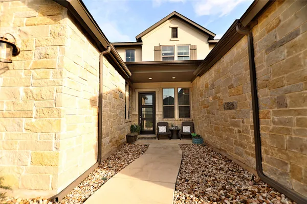 a kitchen with stainless steel appliances granite countertop a table chairs sink refrigerator and microwave