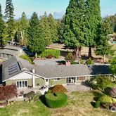 an aerial view of a house with yard swimming pool and outdoor seating