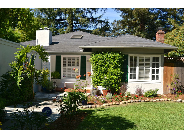 a front view of house with a garden