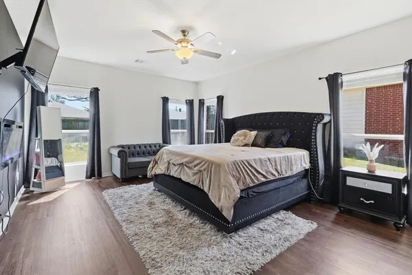 a bedroom with a bed and a chandelier