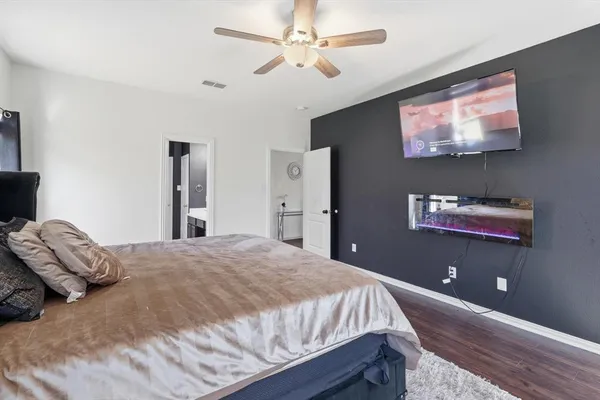a bedroom with a bed and a flat screen tv