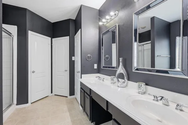 a bathroom with a double vanity sink and mirror