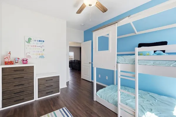 a hallway with hardwood floor and cabinet