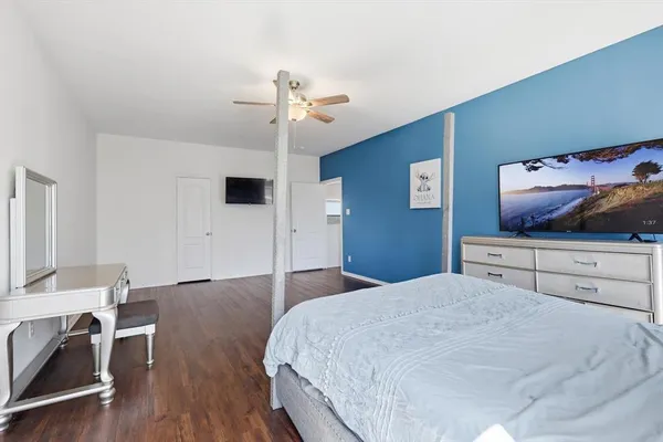a bedroom with a bed and a flat screen tv