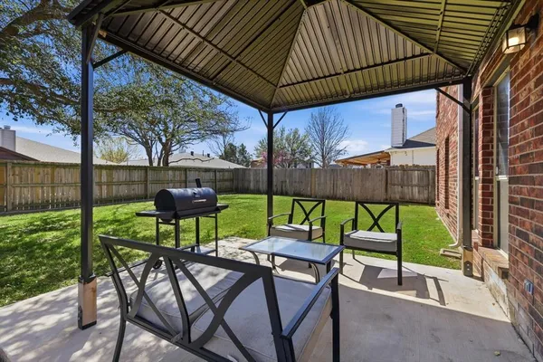 a view of yard with patio