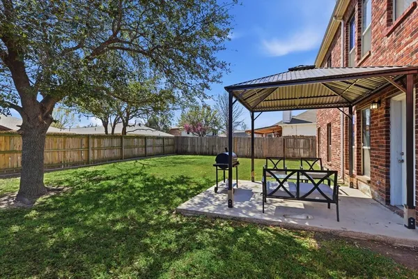 a view of a backyard with table and chairs and a slide
