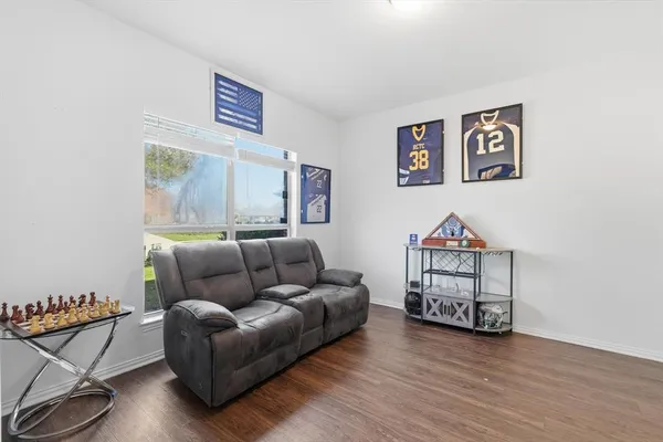 a living room with furniture a rug and wooden floor