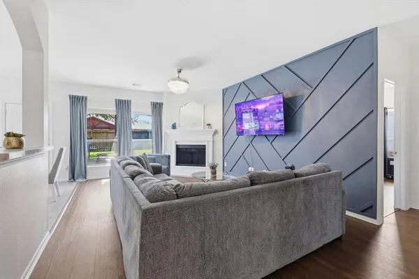 a living room with furniture a fireplace and a flat screen tv