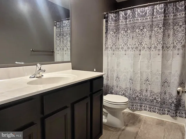 a bathroom with a sink toilet and a mirror